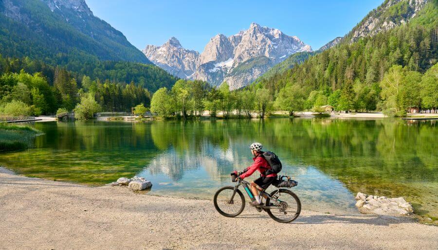 woman on a mountain bike tour at Lake Jezero Jasna in the Triglav National Park near Kranska Gora Julian Alps Slovenia