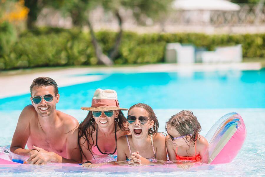 family in pool on holiday